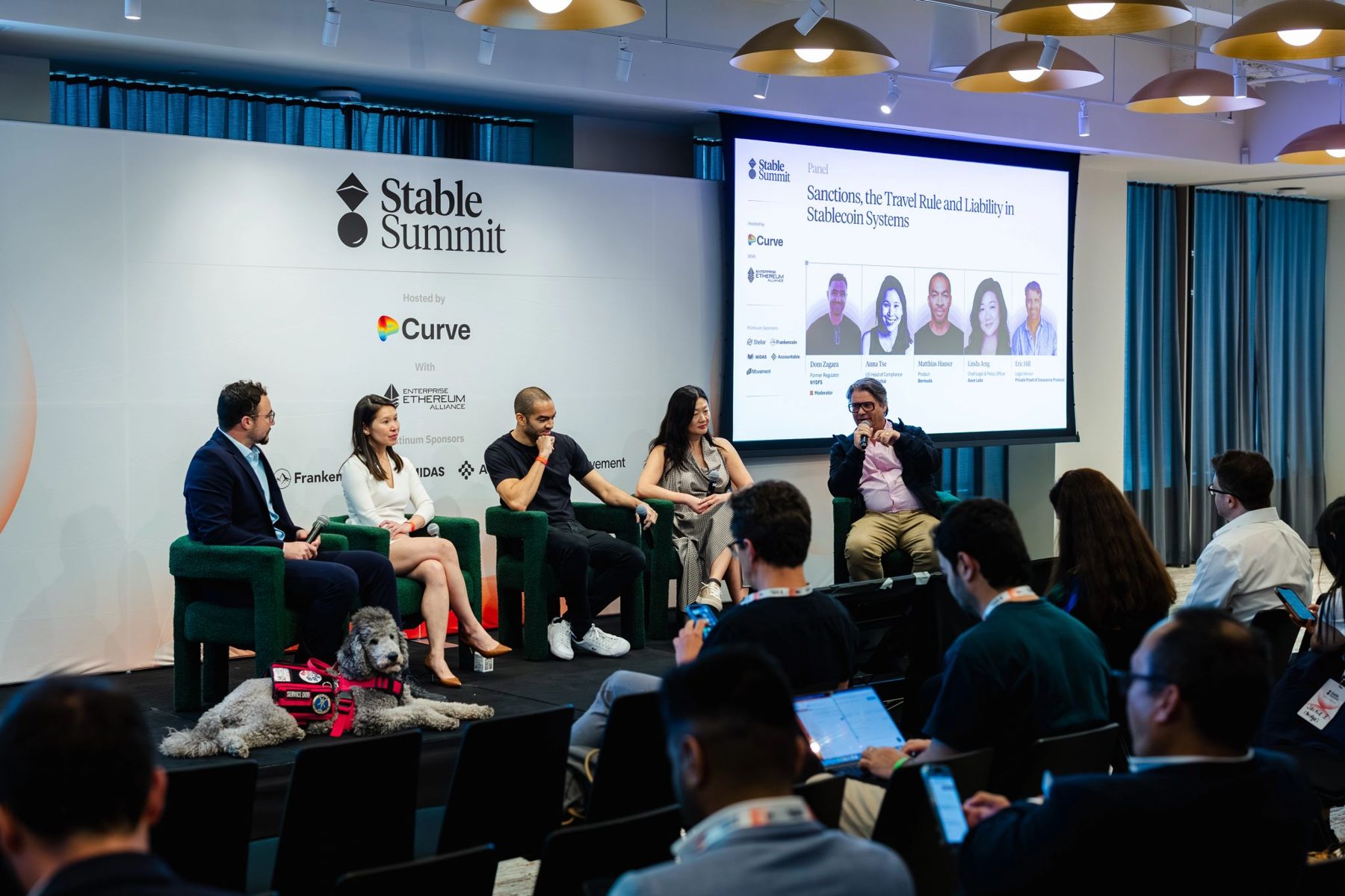 The Sanctions, the Travel Rule and Liability in Stablecoin Systems panel on stage at Stable Summit, five speakers seated with Blaze resting at the stage edge